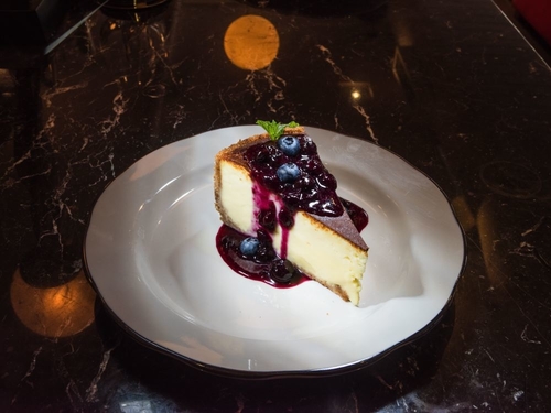 Cheesecake with blueberries and blueberry drizzle on top