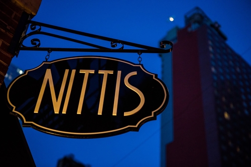 Nittis' gold and black sign hanging outside