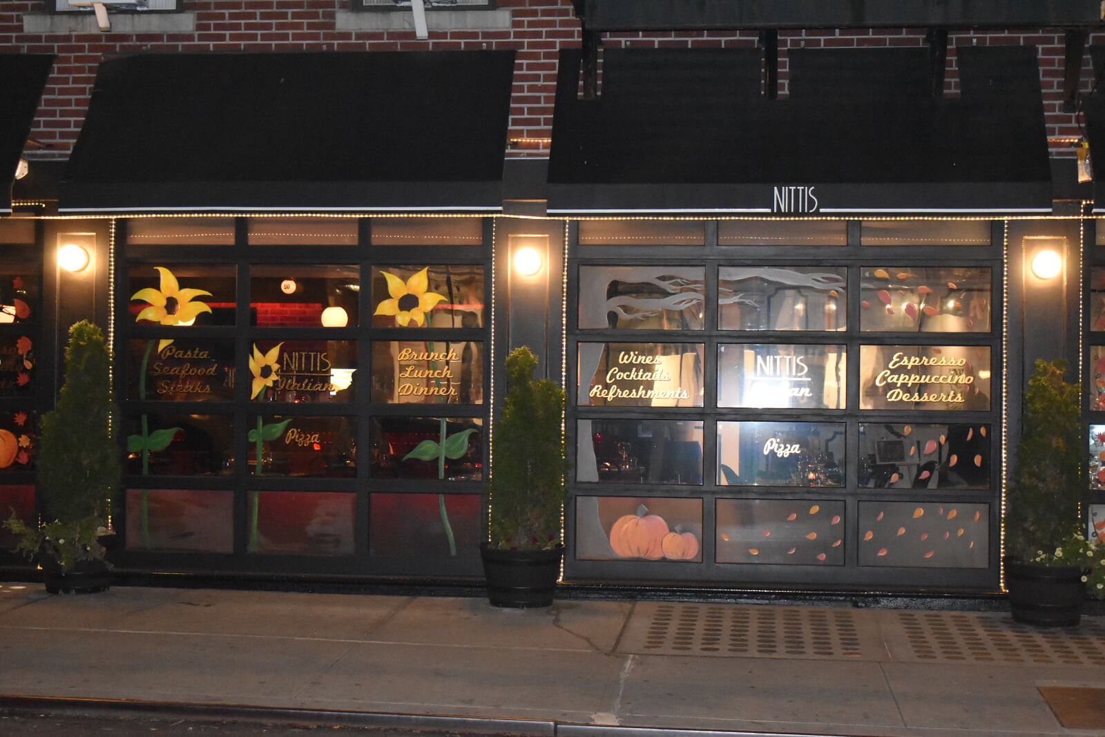 Street view of the restaurant with pumpkins and flowers painted on the windows